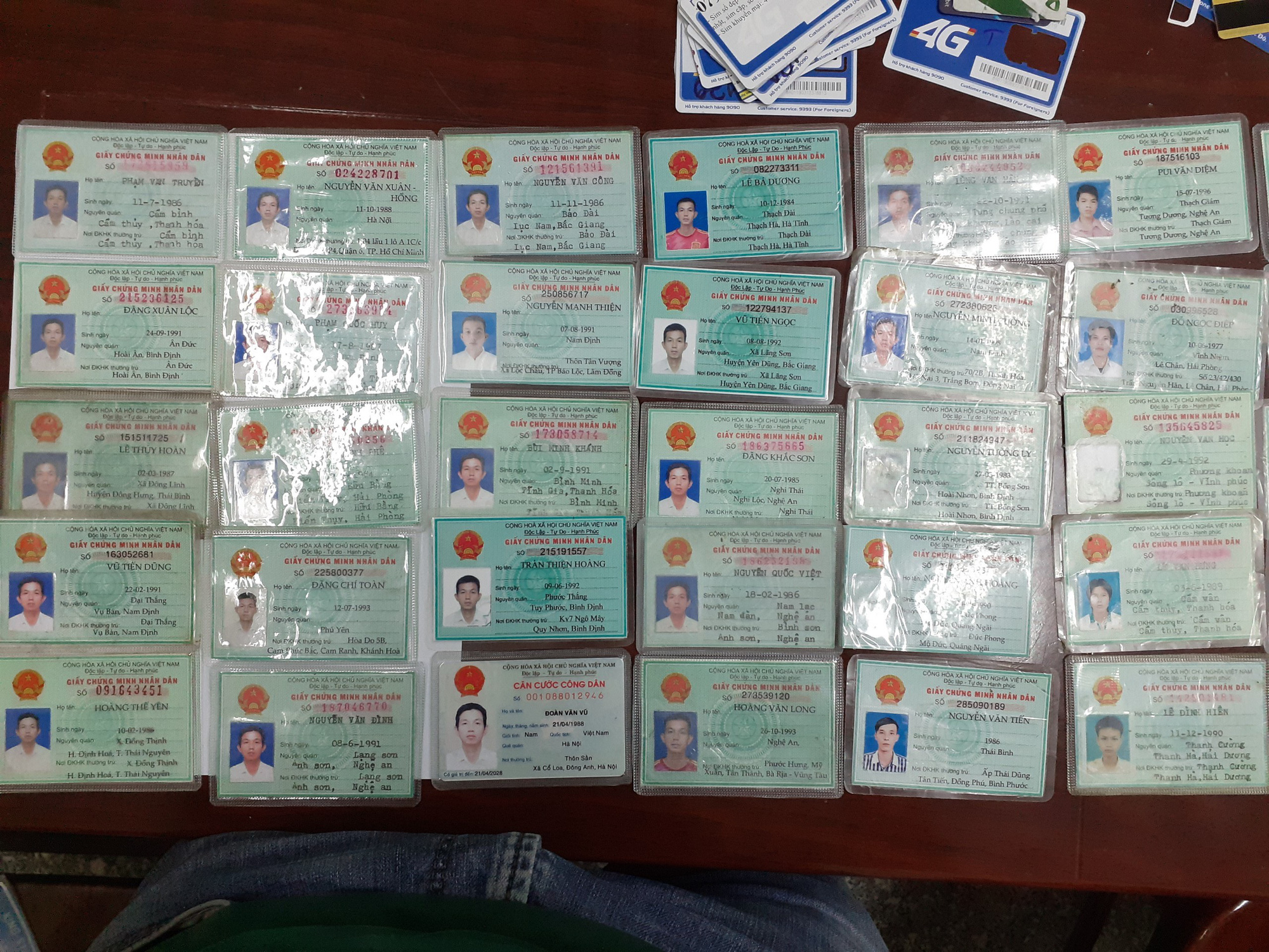 Forged IDs, once used by the fraud ring to set up bank accounts, are seen in this photo. Photo: Thuong Hien / Tuoi Tre