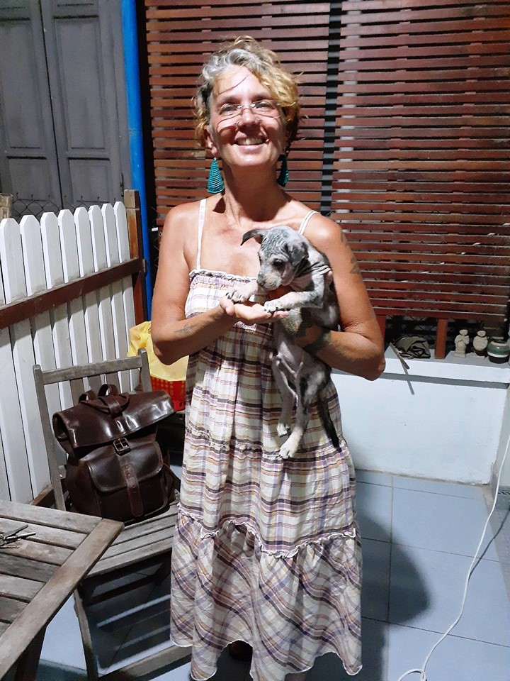 Angelique, the foster parent for the puppy found by the author outside his home in central Vietnam, are seen with the animal in this supplied photo.