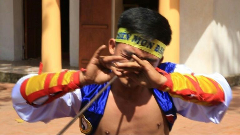 Le Van Thang, 28, student of the centuries-old martial art of Thien Mon Dao, bends a construction rebar against his eye socket inside the Bach Linh temple compound at Du Xa Thuong village in Hanoi, Vietnam. Photo: AFP