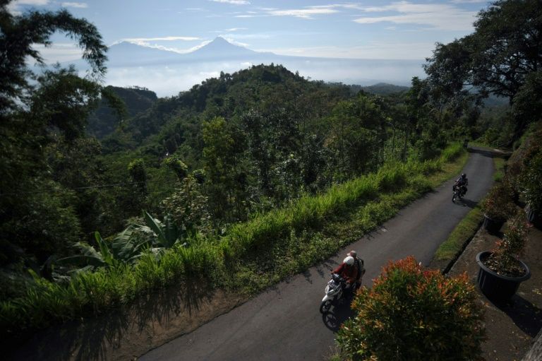 This photo taken on May 20, 2020 shows elementary school teachers riding their motorbicycles to their students' homes to teach in Magelang, Central Java, after schools were closed due to the COVID-19 outbreak. Photo: AFP