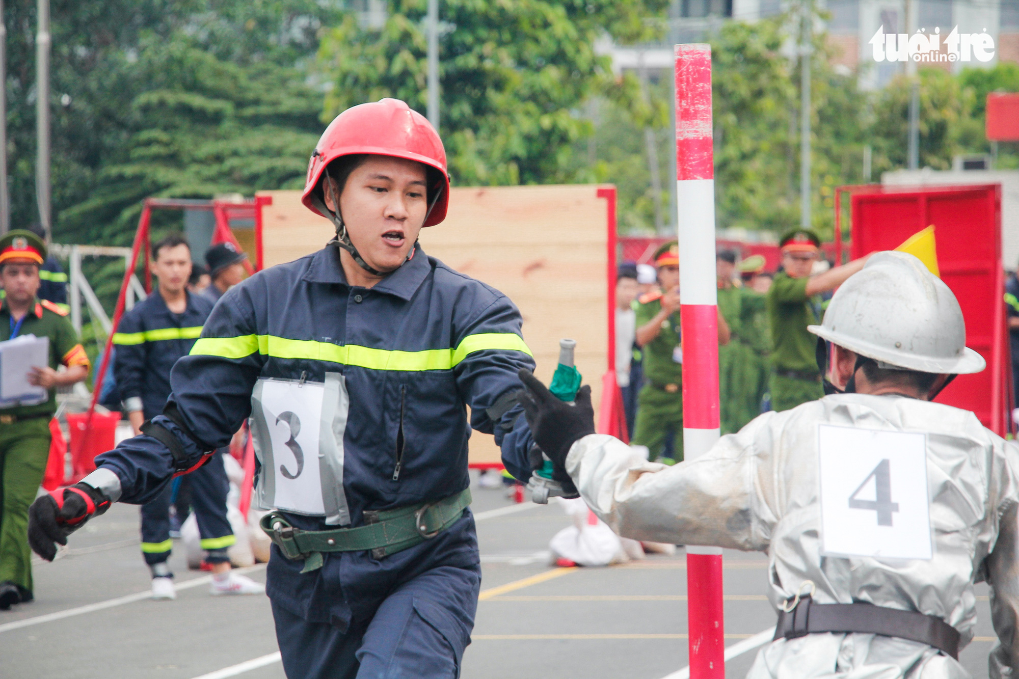 Firefighters participate in a relay race during a firefighting and rescue competition in Ho Chi Minh City, June 16, 2020. Photo: Chau Tuan / Tuoi Tre