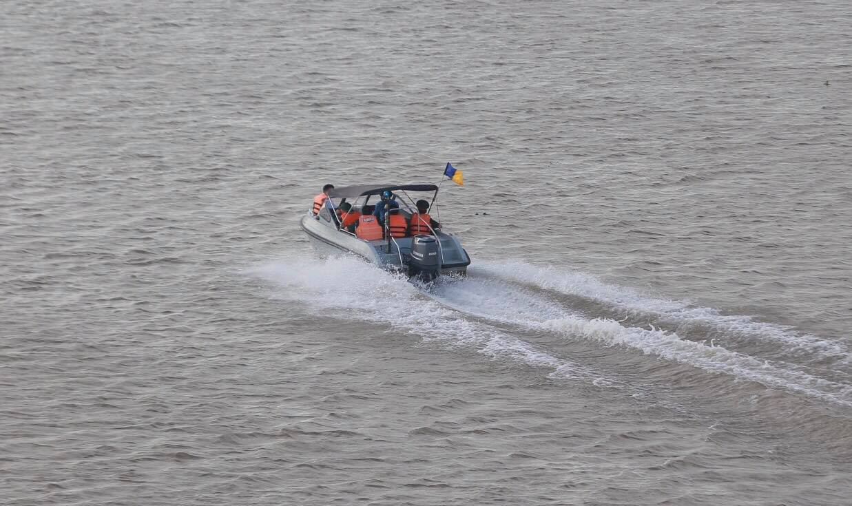 Military officers travel on a speedboat to the location where an unexploded bomb is discovered in Hanoi, June 22, 2020. Photo: Chi Tue / Tuoi Tre