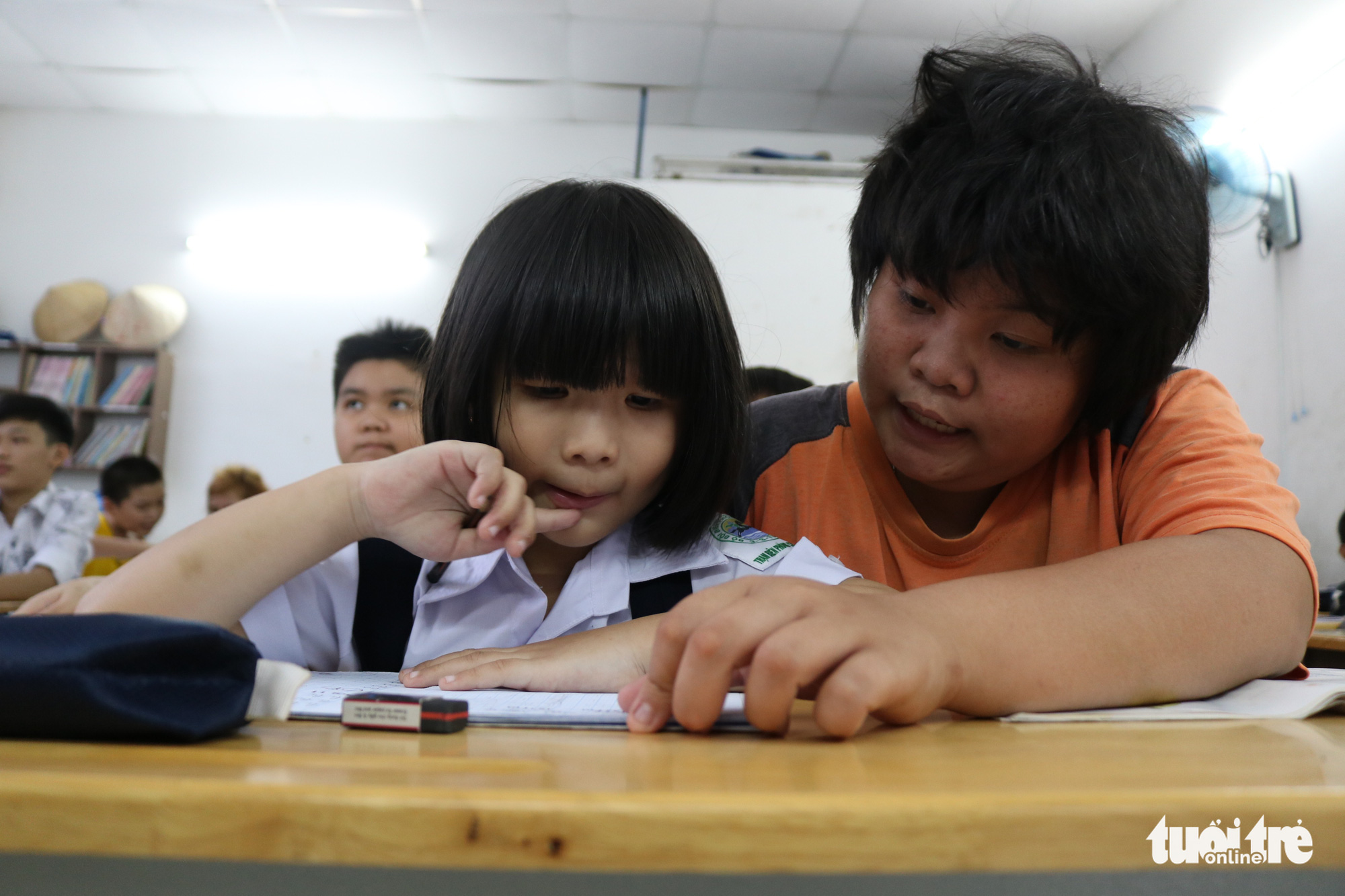 A student (right) helps his fellow classmate with homework in this special class for underprivileged children in Ho Chi Minh City, Vietnam. Photo: Ngoc Phuong / Tuoi Tre