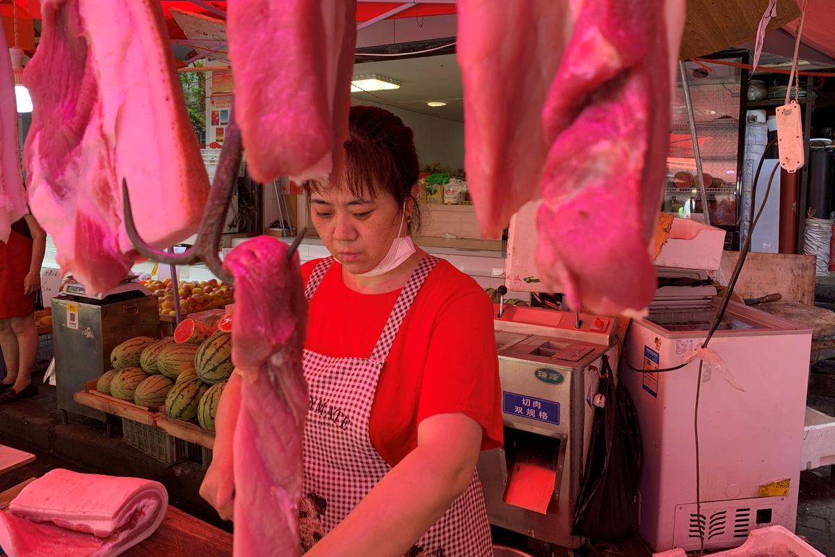 A vendor is seen at a pork stall at a market following the coronavirus disease (COVID-19) outbreak in Wuhan, Hubei province, China June 30, 2020. Photo: Reuters