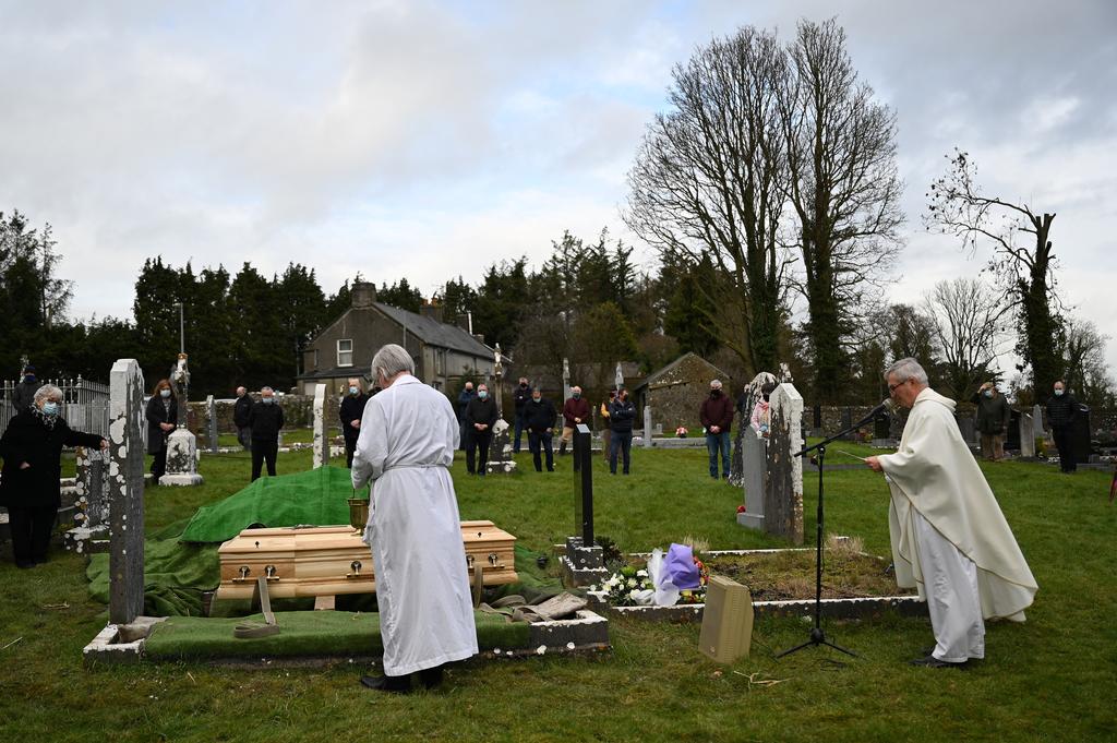 Priests Fr. Liam Everard and Fr. Tom Breen lead the burial mass at Fethard Parish church with a government imposed limit of mourners for a recently deceased local man whose funeral undertaker and publican Jasper Murphy of McCarthy's Bar is directing, amid the coronavirus disease (COVID-19) pandemic, in the County Tipperary town of Fethard, Ireland, February 3, 2021. Photo: Reuters