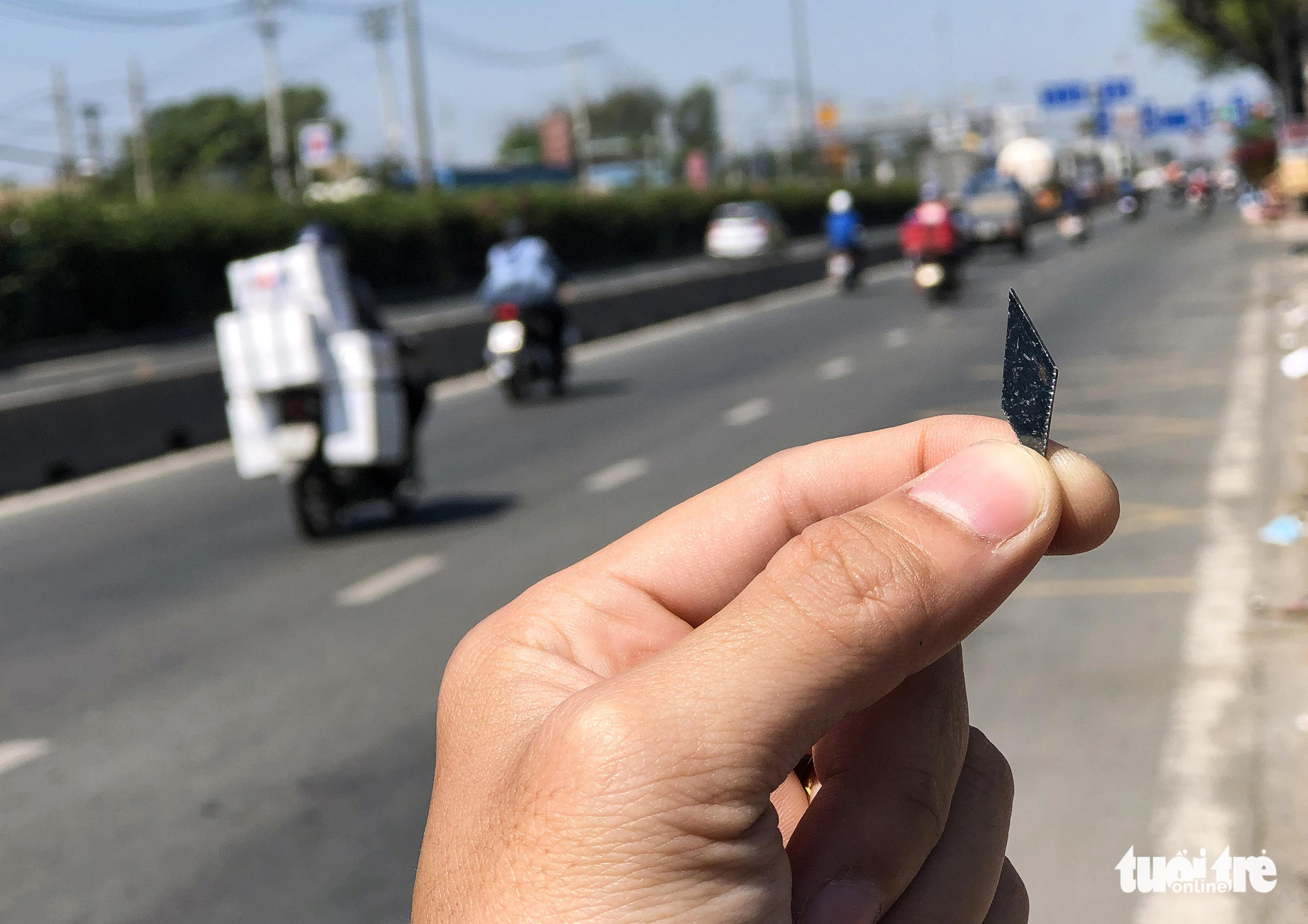 A tire-puncturing nail is found on a street in Ho Chi Minh City. Photo: Chau Tuan / Tuoi Tre