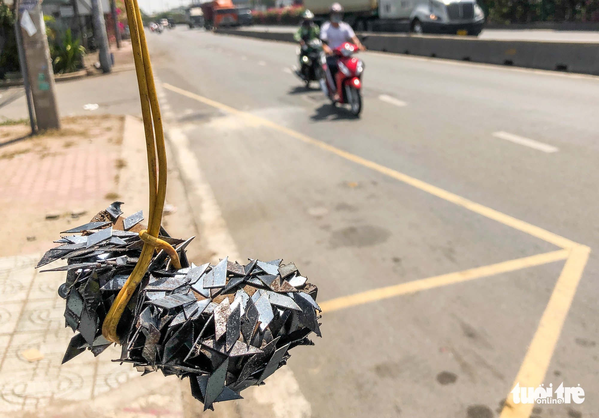 Tire-puncturing nails are collected from a street in Ho Chi Minh City. Photo: Chau Tuan / Tuoi Tre